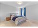 Cozy bedroom with plush carpeting, a comfortable bed, and bright blue curtains at 2705 April Springs View, Carmel, IN 46074
