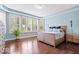 This bedroom has a large bay window with shutter blinds and a wooden bed frame at 2705 April Springs View, Carmel, IN 46074