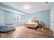 Tranquil bedroom with light blue walls, wood floors, a queen sized bed, and soft natural light at 2705 April Springs View, Carmel, IN 46074