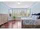 Bright bedroom with bay window, hardwood floors, natural light, and rustic wood furnishings at 2705 April Springs View, Carmel, IN 46074