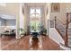 Spacious dining area with hardwood floors and high ceilings adjacent to a living area and staircase at 2705 April Springs View, Carmel, IN 46074