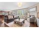 Inviting living area with a fireplace, large windows, and open access to a modern kitchen at 2705 April Springs View, Carmel, IN 46074
