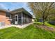 View of the backyard with a screened-in porch, tool shed and manicured lawn at 273 N Serenity Way, Greenwood, IN 46142