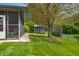 Serene backyard featuring mature tree, tool shed, and screened-in porch for outdoor living at 273 N Serenity Way, Greenwood, IN 46142