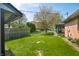 Beautiful backyard with manicured lawn, mature tree, and screened porch, ideal for outdoor living at 273 N Serenity Way, Greenwood, IN 46142