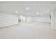 Bright, carpeted basement featuring recessed lights and an open layout suitable for various uses at 273 N Serenity Way, Greenwood, IN 46142
