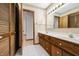 Traditional bathroom featuring a double sink vanity with wood cabinets and a bright mirror with decorative border at 273 N Serenity Way, Greenwood, IN 46142