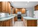Classic kitchen with oak cabinets, stainless steel appliances, and a tiled floor at 273 N Serenity Way, Greenwood, IN 46142