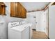 Laundry room featuring a washer, a dryer, and overhead cabinets for storage space at 273 N Serenity Way, Greenwood, IN 46142