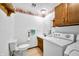 Bright laundry room equipped with essential appliances, storage cabinets, and accessible fixtures at 273 N Serenity Way, Greenwood, IN 46142