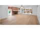 Bright living room with fireplace, hardwood floors, and view into open kitchen at 273 N Serenity Way, Greenwood, IN 46142