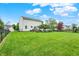 Expansive backyard featuring a well-maintained lawn, mature trees, and secure fencing, offering privacy and space at 286 Fairfax Ln, Greenwood, IN 46142