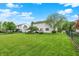 Spacious backyard with lush green lawn, trees, and a fence, perfect for outdoor activities and relaxation at 286 Fairfax Ln, Greenwood, IN 46142