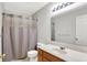 Clean bathroom with a shower-tub combo, vanity, and a large, well-lit mirror at 286 Fairfax Ln, Greenwood, IN 46142