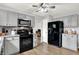 Updated kitchen with sleek gray cabinets, modern appliances, and an adjacent pantry at 286 Fairfax Ln, Greenwood, IN 46142