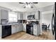 Well-lit kitchen boasts gray cabinetry, modern appliances, and a view into the dining area at 286 Fairfax Ln, Greenwood, IN 46142