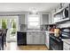 Bright kitchen features gray cabinets, stainless steel appliances, and natural light at 286 Fairfax Ln, Greenwood, IN 46142