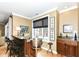 Home bar area featuring a counter with stools, built-in cabinets, and city views at 333 Massachusetts Ave # 303, Indianapolis, IN 46204