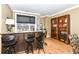 Stylish bar area with seating, a built-in cooler, granite countertops, and city views at 333 Massachusetts Ave # 303, Indianapolis, IN 46204