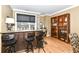 Modern bar area featuring custom cabinetry, bar seating, and a built-in display shelf at 333 Massachusetts Ave # 303, Indianapolis, IN 46204