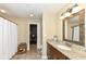 Bathroom features a vanity with granite countertop, decorative mirror, and tiled floor at 333 Massachusetts Ave # 303, Indianapolis, IN 46204