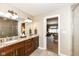 Bathroom showcasing a vanity with dual sinks, granite countertops, and modern lighting at 333 Massachusetts Ave # 303, Indianapolis, IN 46204