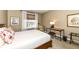 Bedroom featuring a bed, woven chair, desk, and artwork for a touch of comfort and style at 333 Massachusetts Ave # 303, Indianapolis, IN 46204