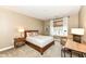 Cozy bedroom featuring a full bed, end table, woven chair, and desk for comfortable living at 333 Massachusetts Ave # 303, Indianapolis, IN 46204