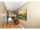 Bright hallway featuring neutral walls, modern art and light hardwood flooring that leads to living spaces at 333 Massachusetts Ave # 303, Indianapolis, IN 46204