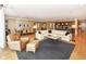 Spacious open living room featuring hardwood floors, a cozy seating area, dining room, and modern kitchen at 333 Massachusetts Ave # 303, Indianapolis, IN 46204