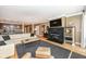 Open-concept living room with a modern fireplace, TV, comfortable seating, and kitchen view at 333 Massachusetts Ave # 303, Indianapolis, IN 46204