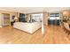 Large living room with hardwood floors, a fireplace, a wet bar and access to an outdoor balcony at 333 Massachusetts Ave # 303, Indianapolis, IN 46204
