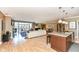 Bright open-concept living area with hardwood floors, island with pendant lights, and balcony access at 333 Massachusetts Ave # 303, Indianapolis, IN 46204