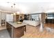 Spacious living room featuring an open floor plan, hardwood floors, and a granite kitchen island at 333 Massachusetts Ave # 303, Indianapolis, IN 46204