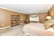 Bedroom with tan walls, carpet floors, and large window offers comfort and convenience at 333 Massachusetts Ave # 303, Indianapolis, IN 46204