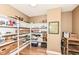 Spacious pantry with wooden shelving and decorative baskets for optimal storage and organization in this home at 333 Massachusetts Ave # 303, Indianapolis, IN 46204