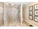 Walk-in shower with clear glass door, neutral tile, and built-in seat offers comfort and style at 333 Massachusetts Ave # 303, Indianapolis, IN 46204