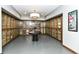 Elegant wine room with glass-enclosed storage cabinets and a sophisticated central table at 333 Massachusetts Ave # 303, Indianapolis, IN 46204