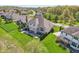 An elevated view of the back of the house, showing the deck, outdoor kitchen and the large green lawn at 3384 Homestretch Dr, Carmel, IN 46032