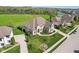Gorgeous home from an aerial view showing its lush landscaping, long driveway, and nearby greenery at 3384 Homestretch Dr, Carmel, IN 46032