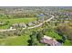 A high angle showcases the neighborhood, green space, landscaping, and architectural home styles at 3384 Homestretch Dr, Carmel, IN 46032