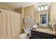 Comfortable bathroom with a dark vanity, a white toilet, and a dark shower curtain at 3384 Homestretch Dr, Carmel, IN 46032