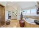 Bright bathroom suite with dual vanities, a soaking tub, a walk-in shower, and ample natural light at 3384 Homestretch Dr, Carmel, IN 46032