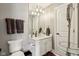 Comfortable bathroom featuring a modern countertop, a stylish mirror, and a white door at 3384 Homestretch Dr, Carmel, IN 46032