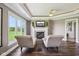 Cozy sitting area with a fireplace, perfect for relaxation in this bedroom retreat with views of the yard at 3384 Homestretch Dr, Carmel, IN 46032