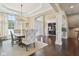 Elegant dining room features a tray ceiling, chandelier, and hardwood floors at 3384 Homestretch Dr, Carmel, IN 46032