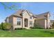 Beautiful two-story home with a manicured lawn, highlighted by the home's blend of stone and brick at 3384 Homestretch Dr, Carmel, IN 46032