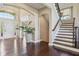 Inviting foyer boasts hardwood floors, soaring ceilings, grand staircase and bright natural light at 3384 Homestretch Dr, Carmel, IN 46032
