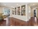 Hallway with built-in bookshelves and hardwood floors at 3384 Homestretch Dr, Carmel, IN 46032