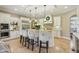 Bright kitchen boasts a large island with bar seating and stainless steel appliances at 3384 Homestretch Dr, Carmel, IN 46032